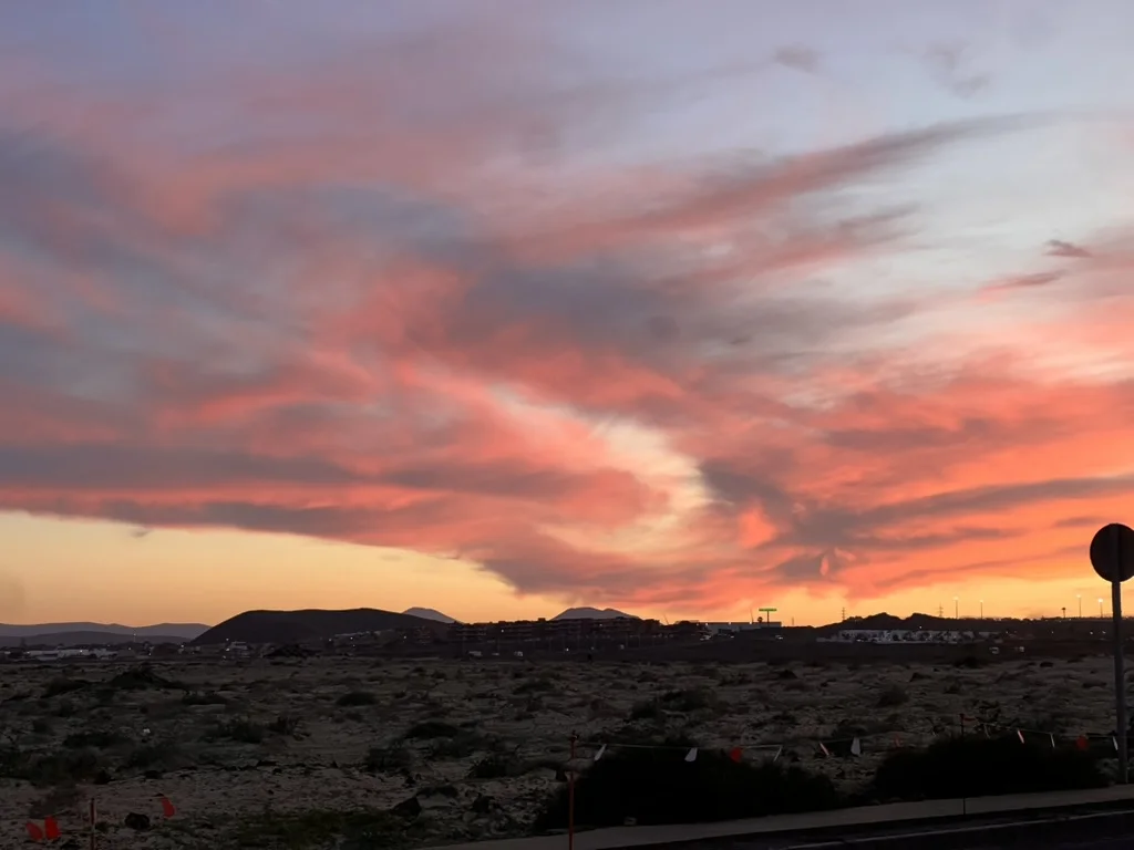 Streaks of pink and orange clouds at dusk